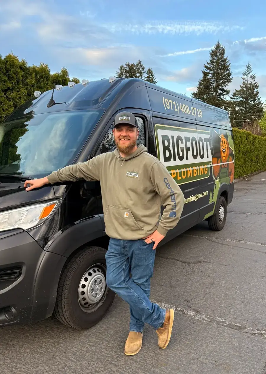 Kevin Brain, owner of Bigfoot Plumbing, beside his Bigfoot Plumbing van in Sandy, Oregon